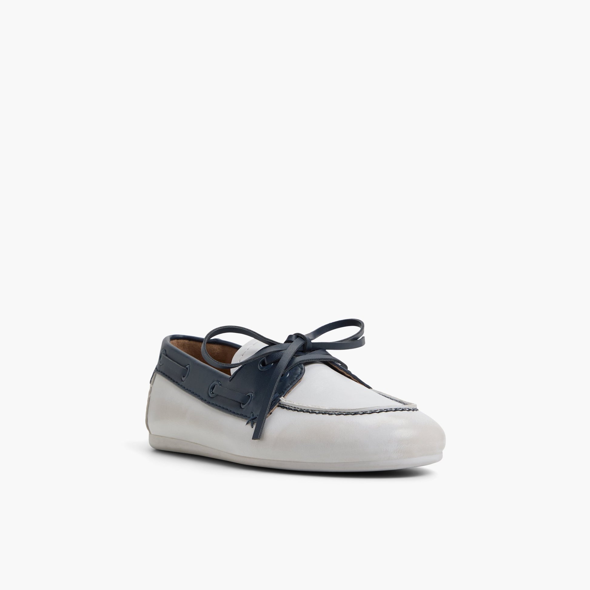 Three-quarter angle of White/Navy Shelly Boat Shoes's front side
