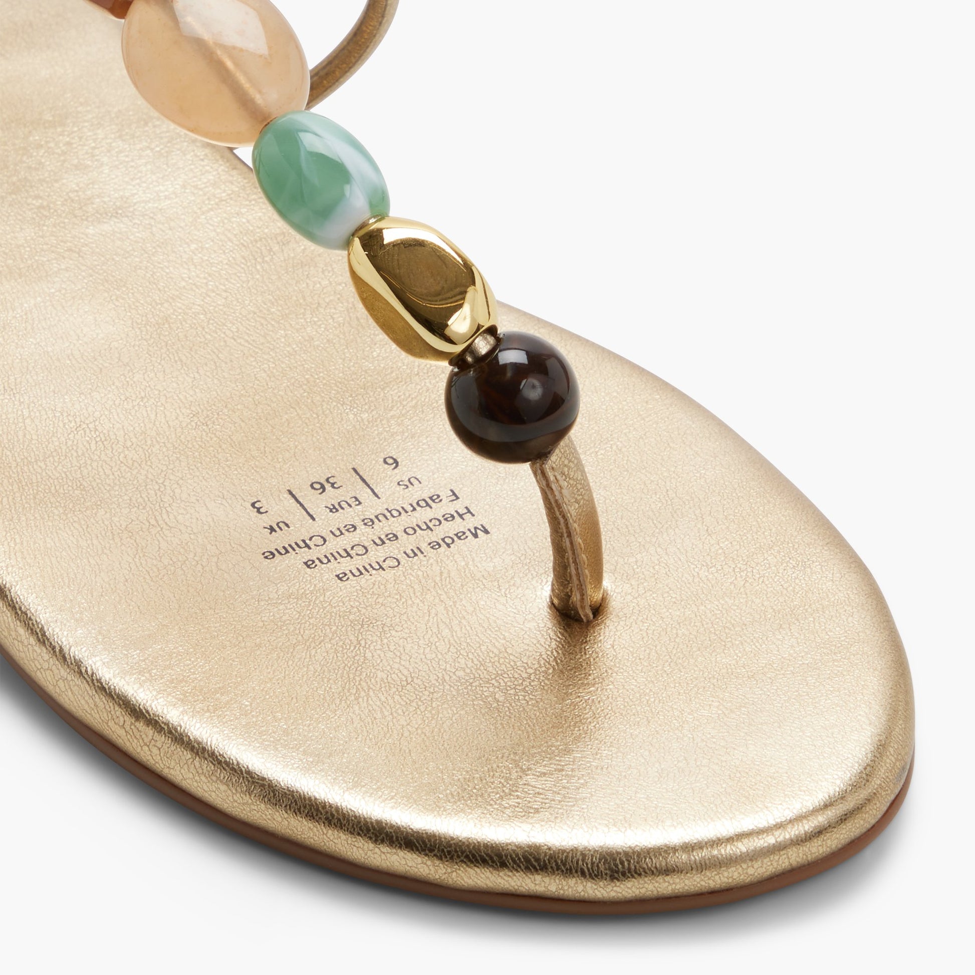 Close-up of the Gold Topaaz T-Bar Thong Sandals